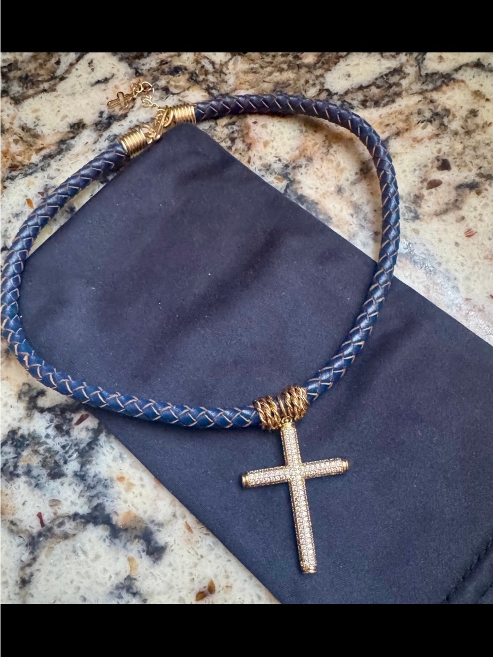 Faux diamond/rhinestone cross pendant on a navy braided leather cord necklace